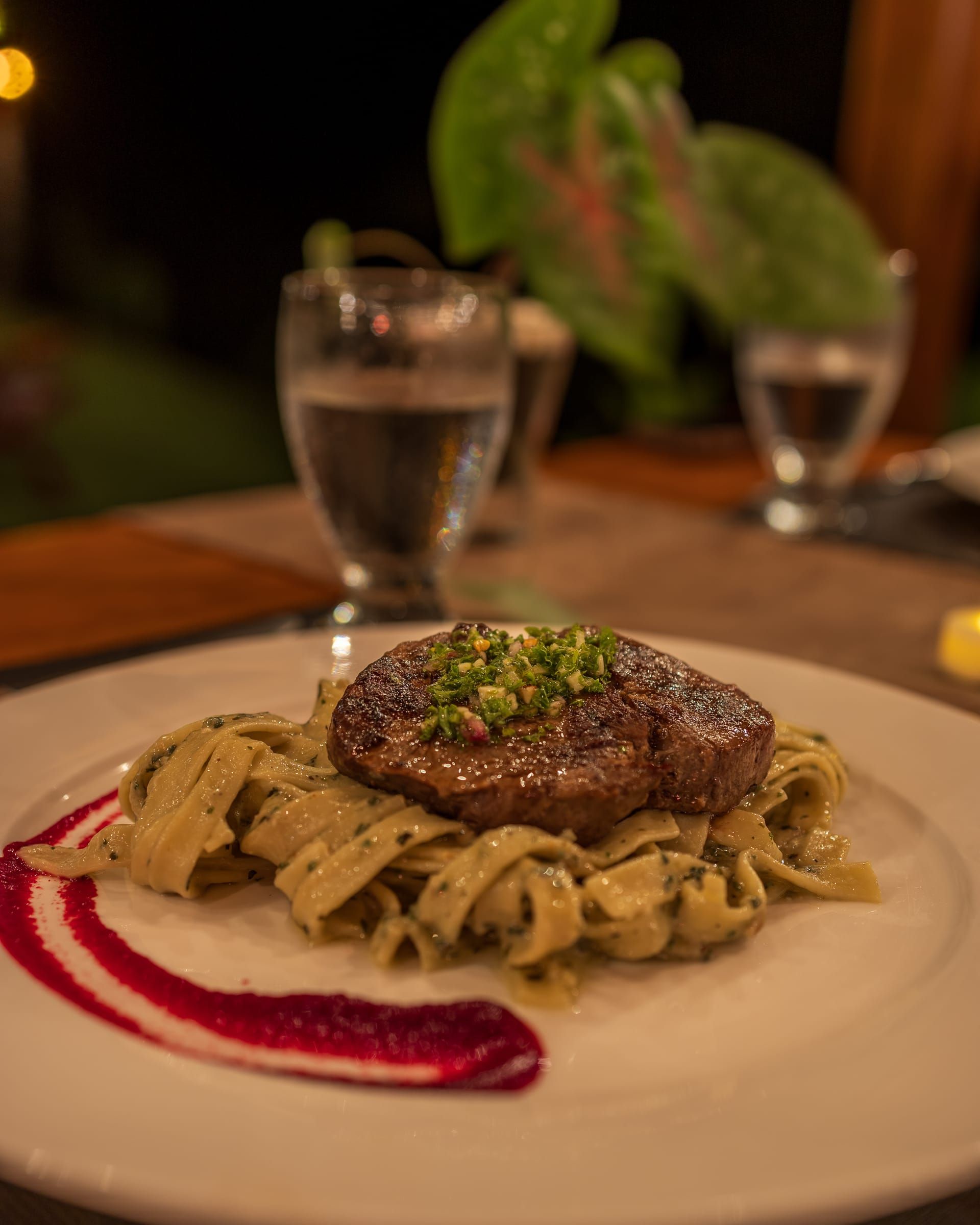Steak on pasta with a red sauce