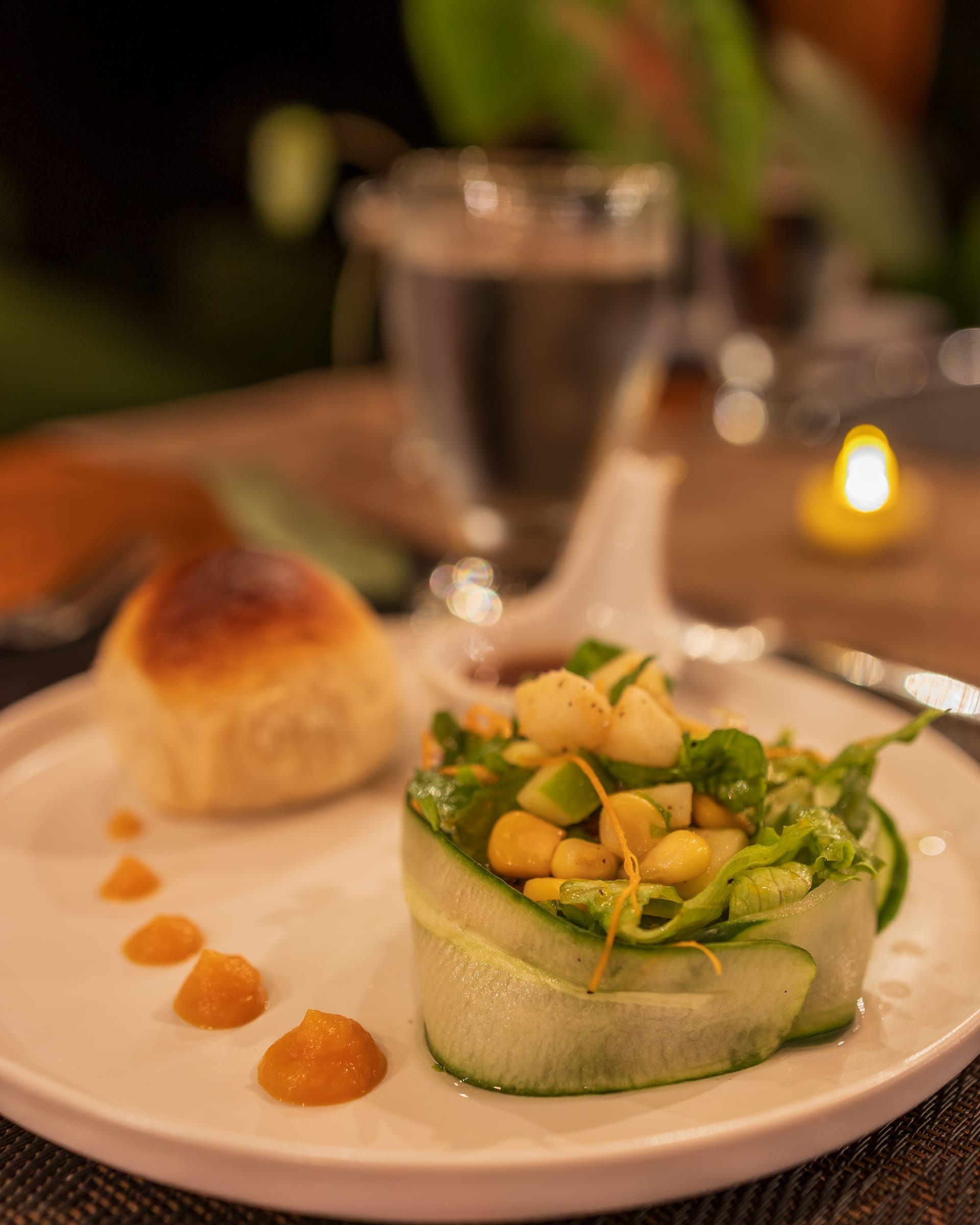 A fresh salad served with a bread roll
