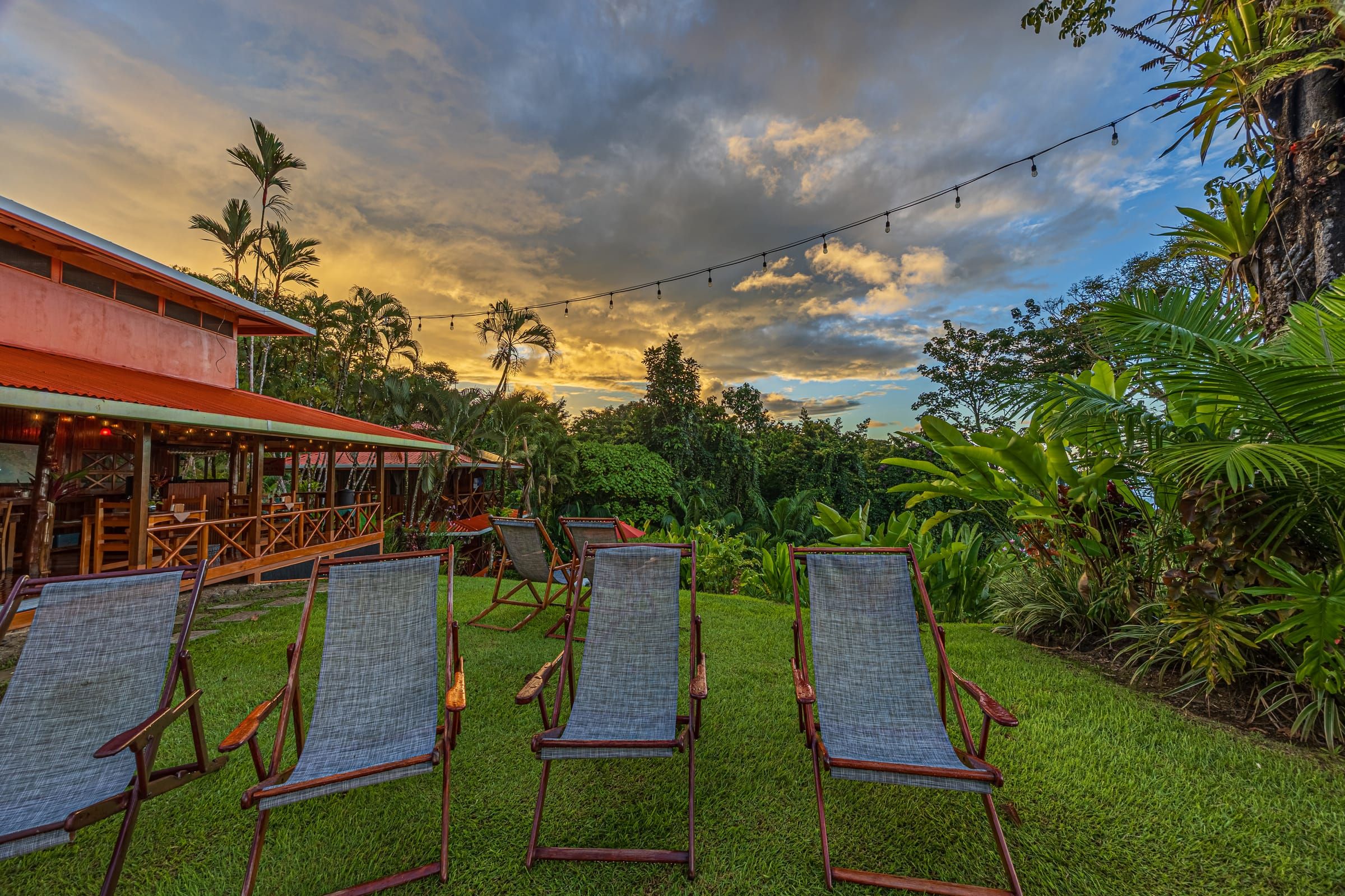 Deck chairs on the lawn beside the restaurant at dusk