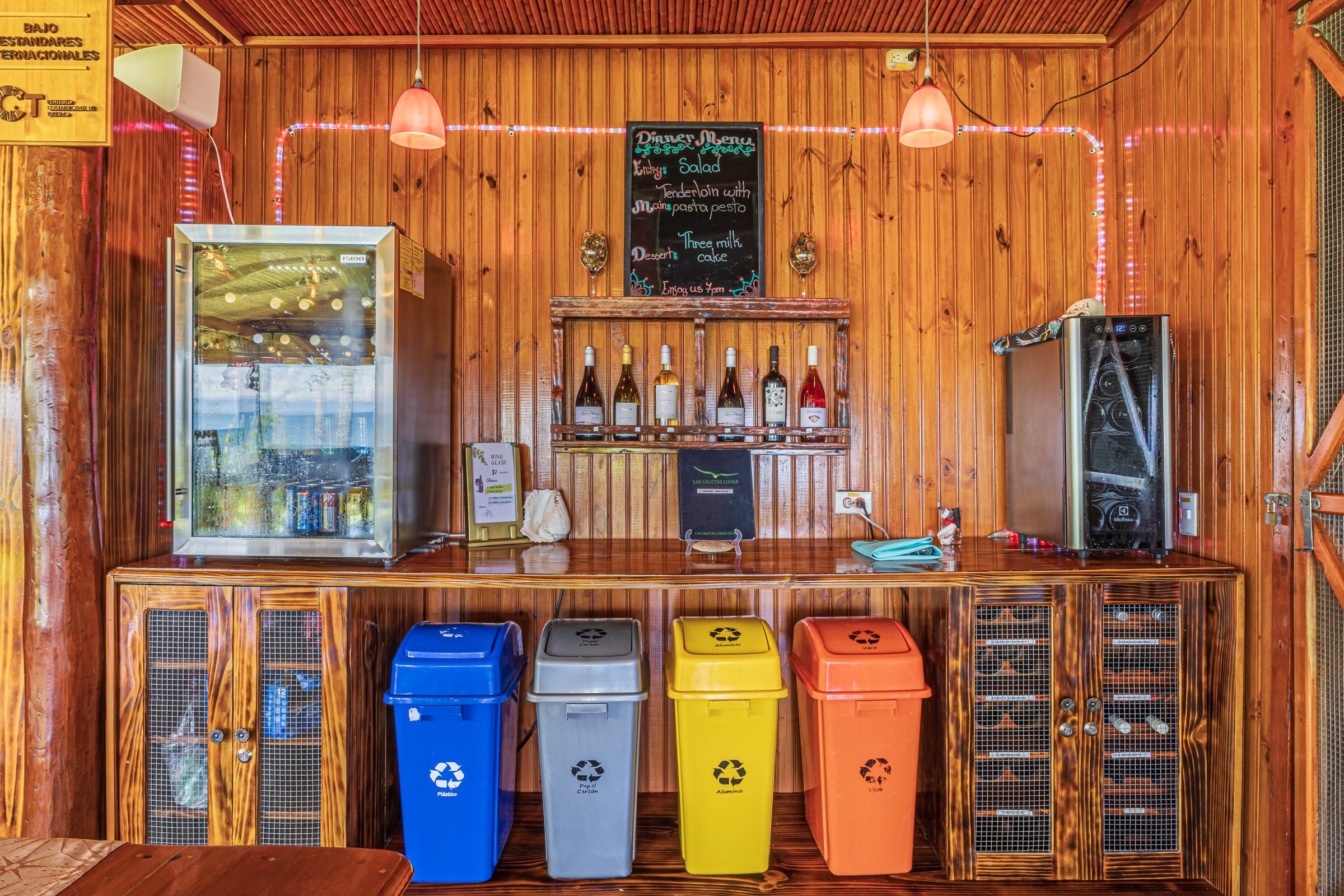 Drinks fridge, wine shelf and colour-coded recycling bins in the restaurant