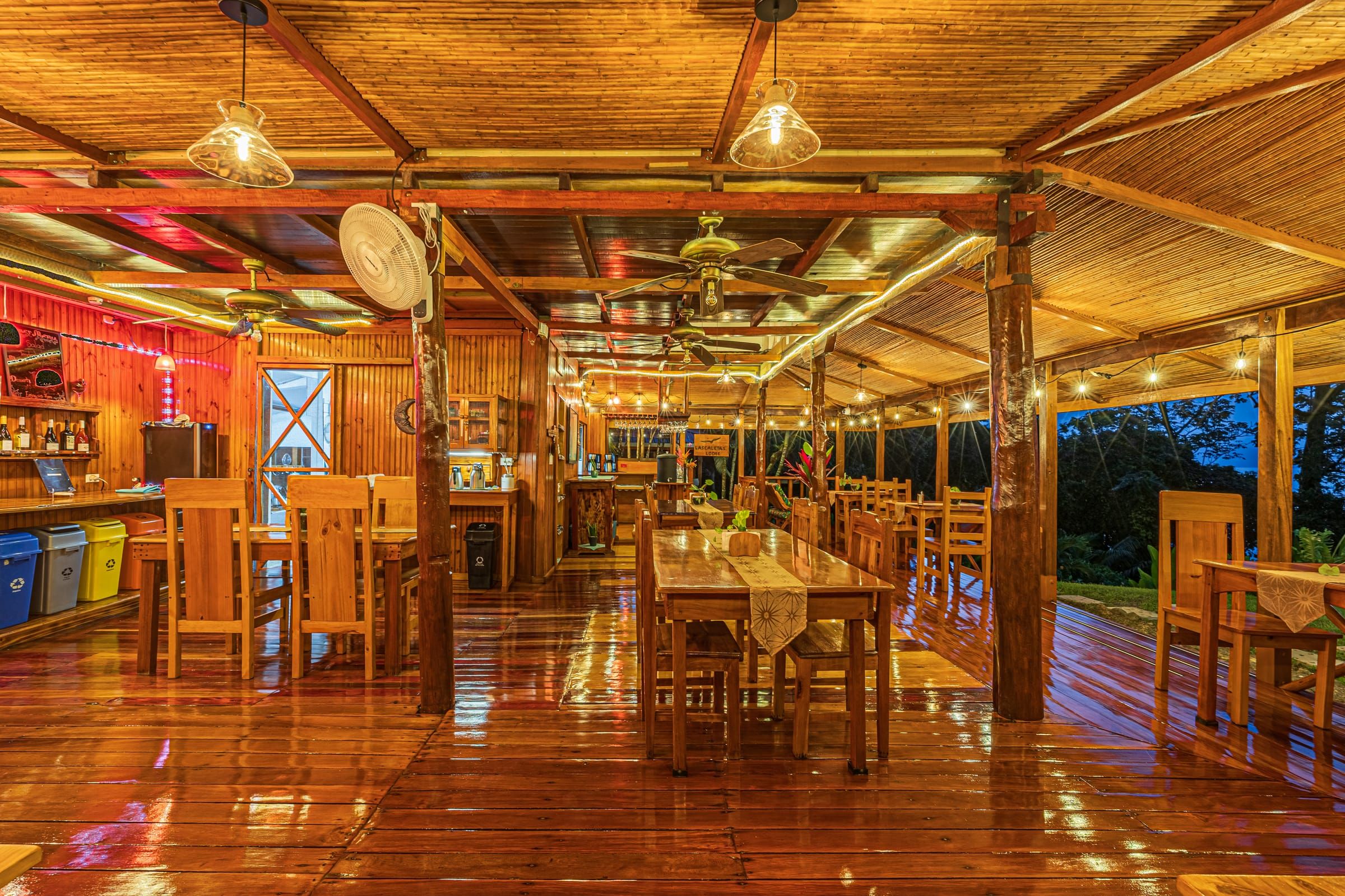 Open-air restaurant with wooden tables and ocean view