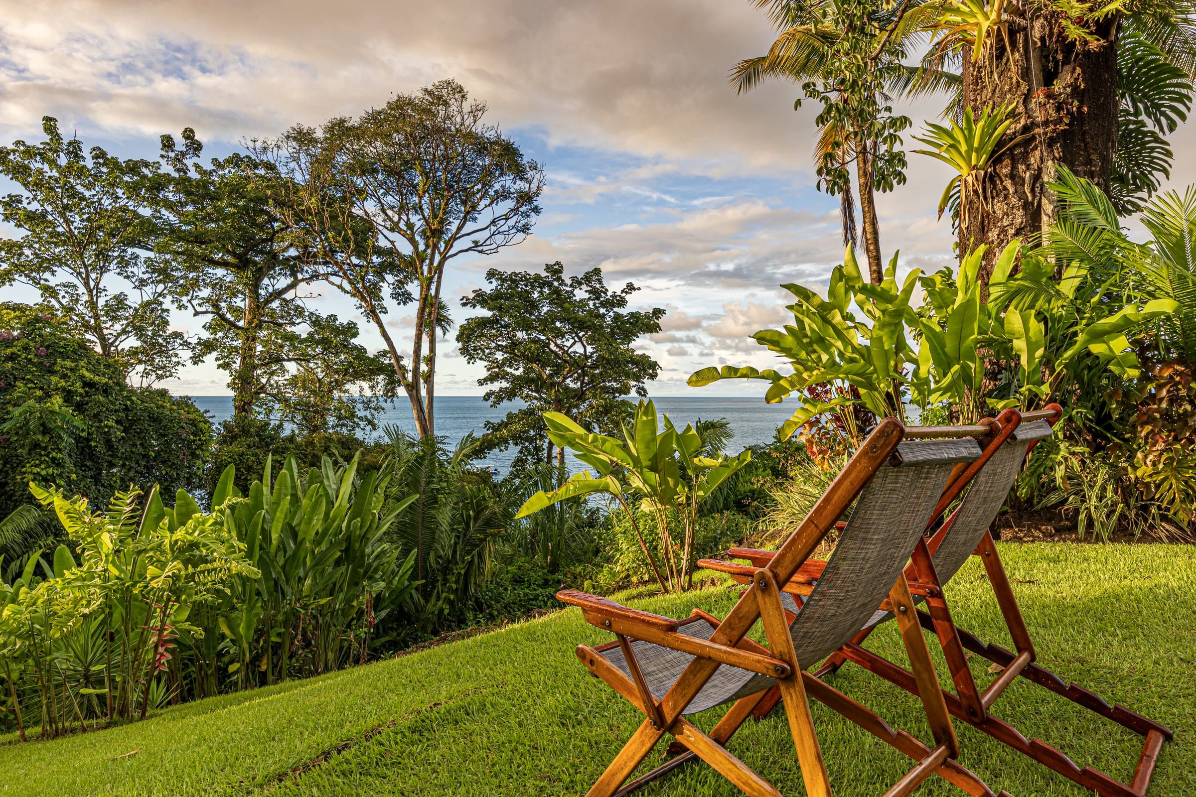 Deck chairs on the lodge lawn overlooking the Pacific